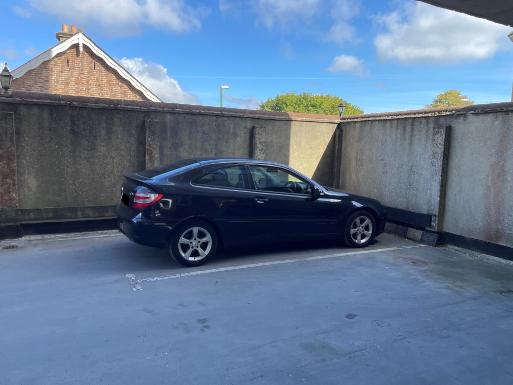 Lot: 48 - TWO-BEDROOM FLAT WITH PARKING IN TOWN CENTRE - View of parking space on first floor car deck